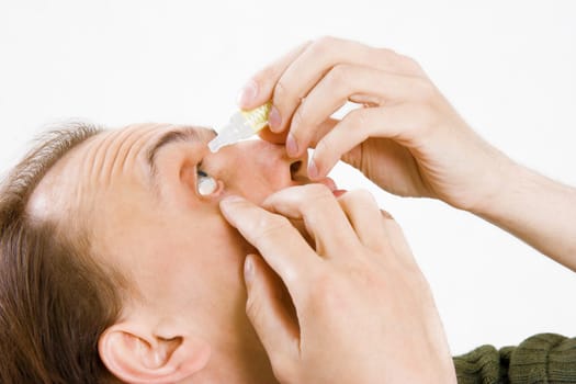 man drips into the eyes of pain medicine