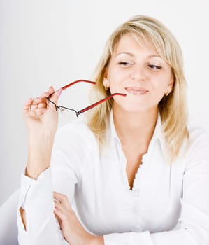 charming blonde with glasses in hand, flirts looks toward