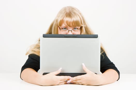 girl hiding behind a laptop on a white background