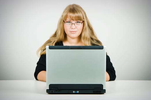 blonde with long beautiful hair with a laptop