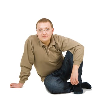 calm young man sits on a white background