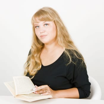 blonde with long beautiful hair, sitting with a book