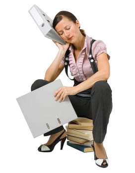 young girl sleeping on the books at an isolated white background