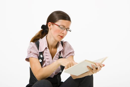 young girl with glasses reading a book