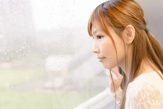 Asian beauty in MRT carriages look through the window into far away, Taipei, Taiwan.