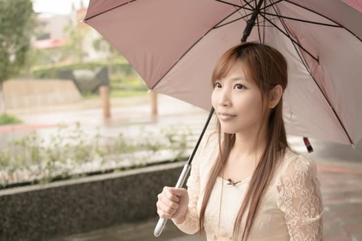 Asian beauty in raining day hold an umbrella in outside, Taipei, Taiwan.