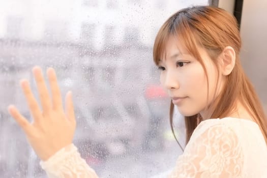 Asian beauty in MRT carriages look through the window into far away, Taipei, Taiwan.