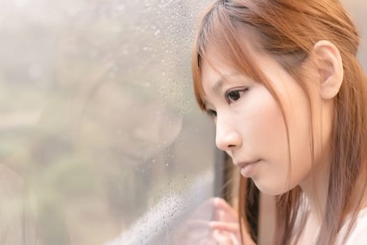 Asian beauty in MRT carriages look through the window into far away, Taipei, Taiwan.