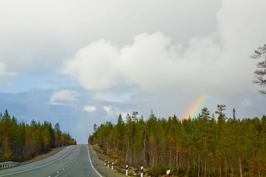 rainbow over the road. Autumn day landscape