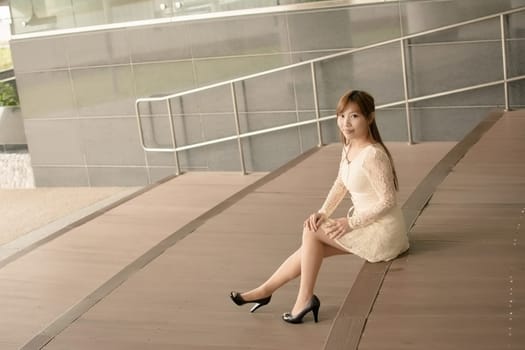Asian beauty sit on ground and look far away in Taipei, Taiwan, Asia.