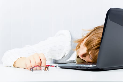 worker, asleep on a laptop in the office