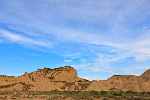 Desert landscape under the cloudy sky, Bardenas Reales, Navarra, Spain