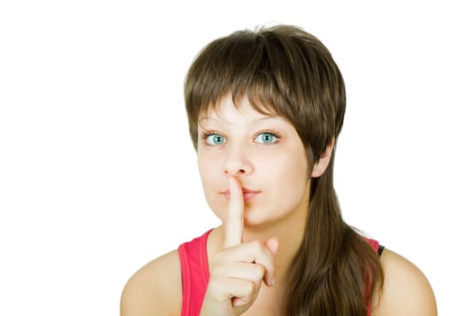 portrait of a beautiful blue-eyed girl clamping finger to lips on an isolated white background