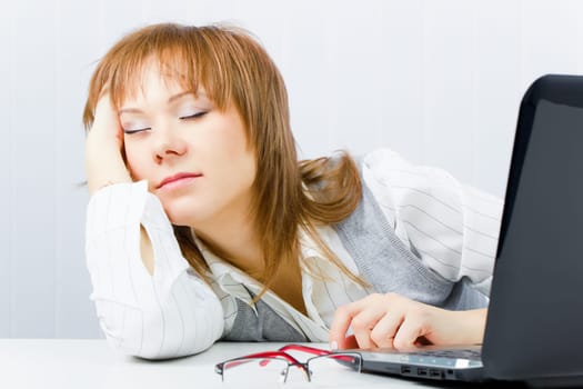worker, asleep on a laptop in the office