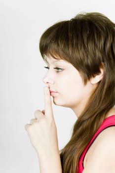 beautiful blue-eyed girl with finger in mouth
