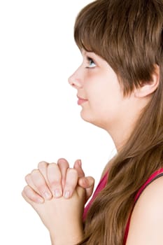 Pretty girl prays his hands clasped on the isolated white background