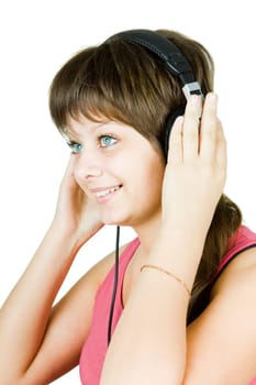 pretty happy blue-eyed girl in headphones listens to music on an isolated white background