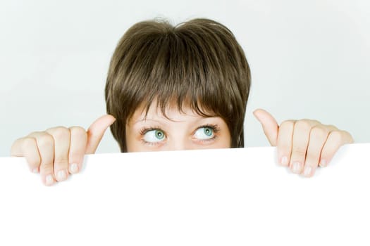 young girl hiding behind a white banner