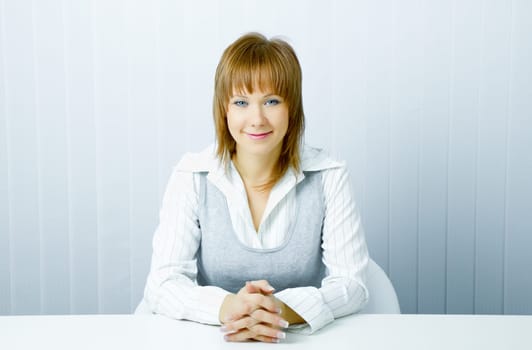 blue-eyed happy attractive young businesswoman in office