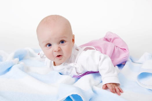 baby girl lying on a white background