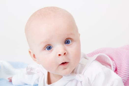 baby girl lying on a white background