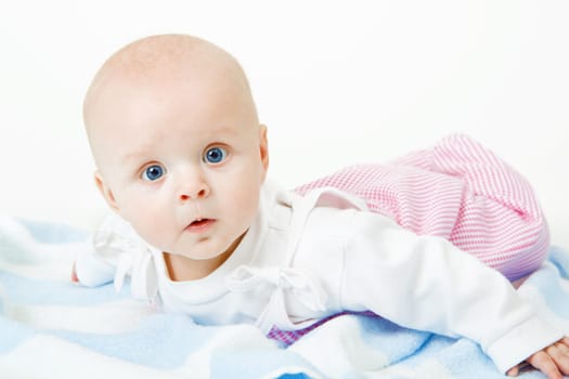 baby girl lying on a white background