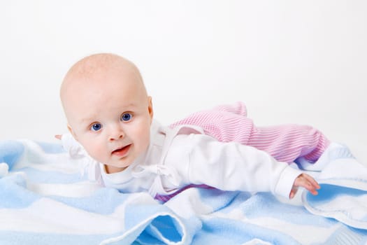 baby on a towel in the studio on a white background