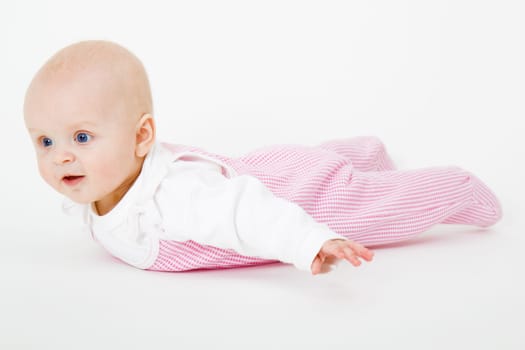 baby girl lying on a white background