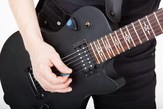 men's hands with a black guitar closeup