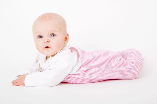 baby girl lying on a white background