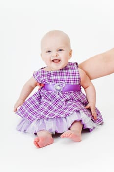 happy baby sitting on a white background
