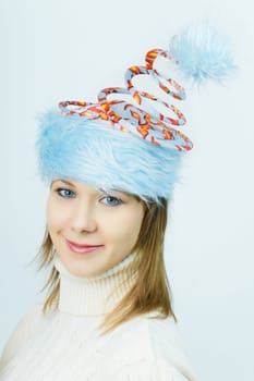 portrait of a beautiful smiling girl in an unusual Christmas hats
