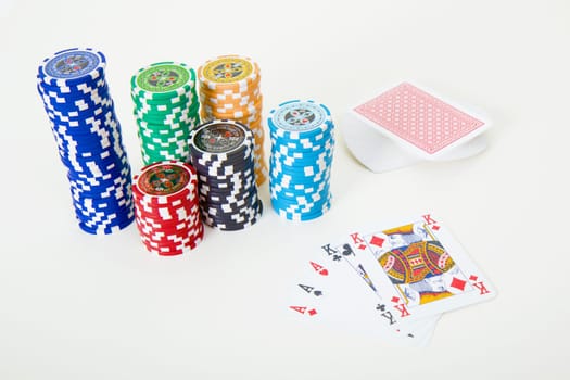 cards and poker chips on a light table