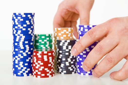 poker chips and hands on a light background