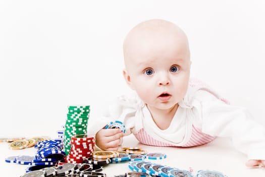 infant with chips for a casino on a white background