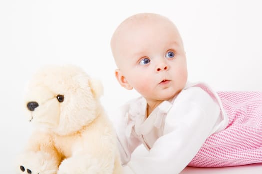 babe with a toy in the studio on a white background