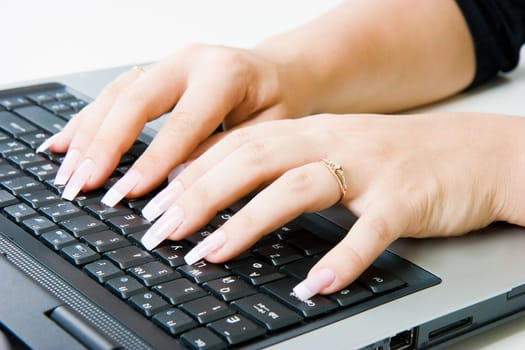 woman's hands with a manicure on a laptop keyboard