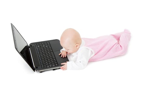 baby with laptop lying on a white background