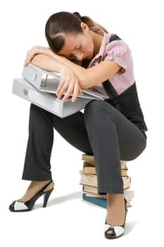 young girl asleep sitting on the books on an isolated background