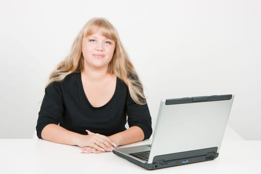 a young girl working on laptop in a bright room