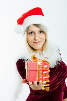 beautiful smiling blonde in a Christmas hat holding a small gift