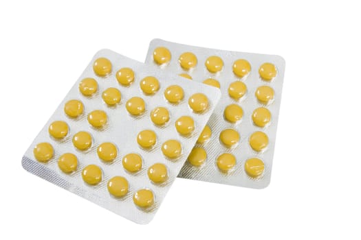 two blisters with round yellow pills isolated on white background