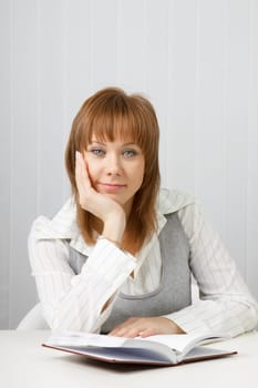 tired attractive young woman in a business office