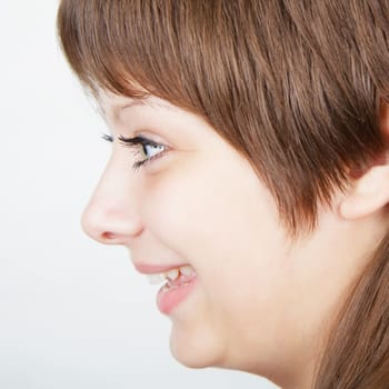attractive girl admired. Portrait in profile against a light background
