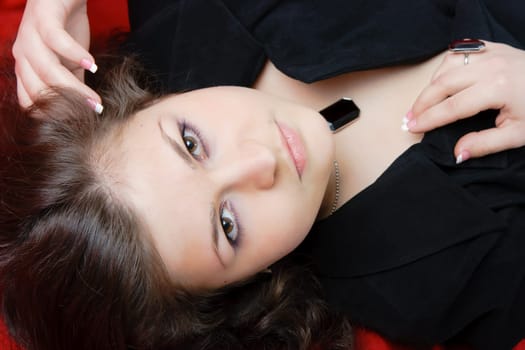 attractive sexy brunette in a black dress. Studio portrait