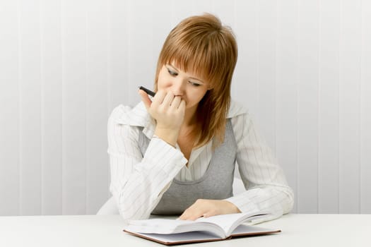 thoughtful girl with a notebook. Secretary in the office.