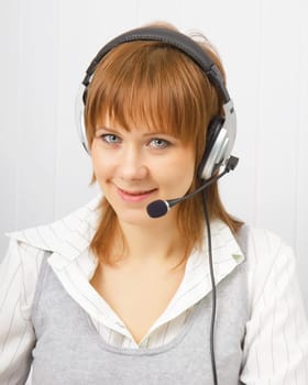 attractive girl in headphones with a microphone. Studio portrait