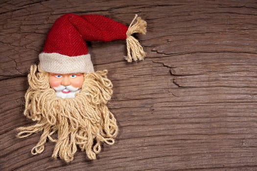 Rustic wooden background with Santa Claus face