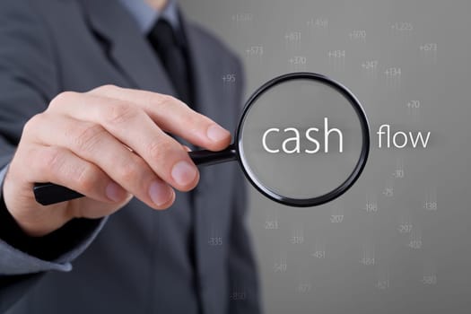 Focus on cash flow and audit of accounts concept. Businessman (auditor) analyze cash flow. Positive numbers fly up, negative numbers fly down.
