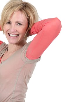 Woman with hands behind head
